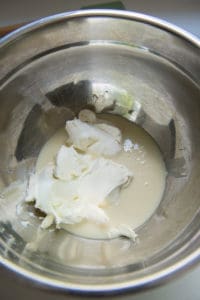 sweetened condensed milk, mascarpone and Greek yogurt in a stainless steel bowl