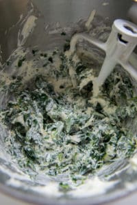spinach artichoke dip in a stainless steel mixing bowl 