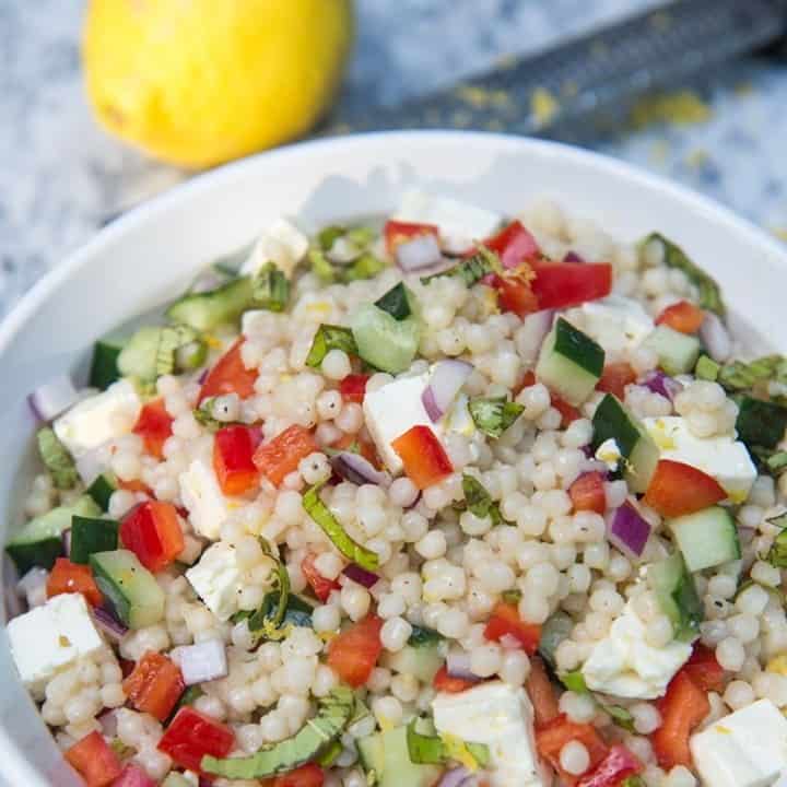 Need a side dish for the 4th of July ??⁣
⁣
Try this super simple Israeli couscous salad with bright summer vegetables, chopped fresh basil, BIG chunks of feta, and a lemon vinaigrette. Light, fresh, and perfect for summertime!⁣
⁣
Link in Bio :)